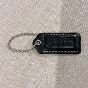 Coach deep navy and brown leather purse tag.